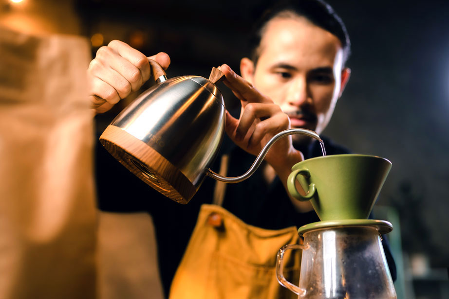 barista pouring coffee